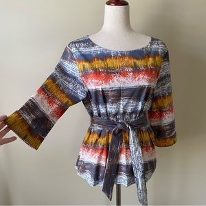 Emerson Rose- Top. Pattern includes colors Orange, Yellow, Grey, White. Size M